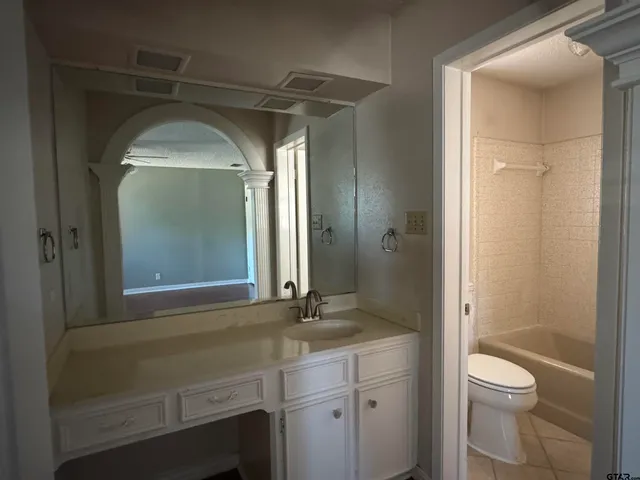 a view of a room with wooden floor and a ceiling fan