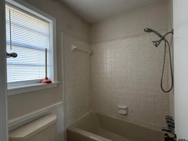 a bathroom with a bathtub and shower