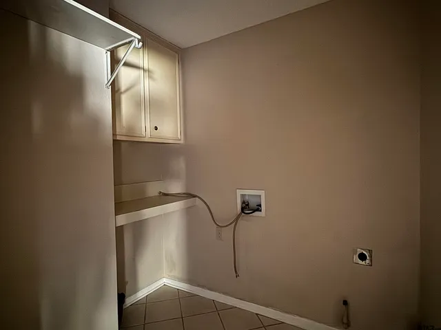 a view of an empty room with a fireplace and a window