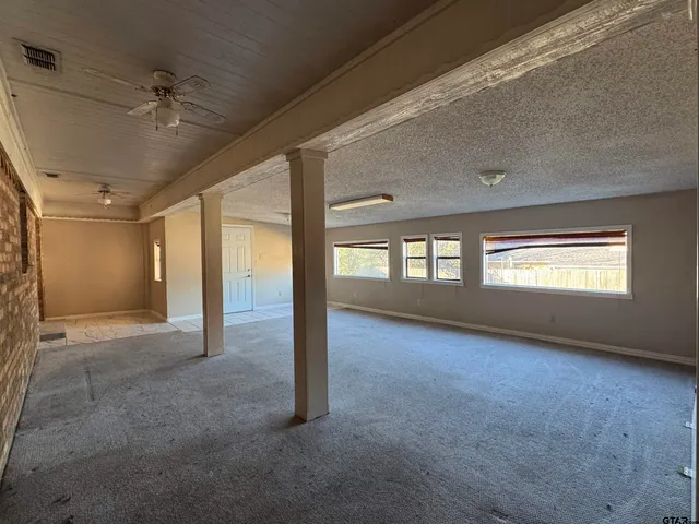 a view of a balcony with yard
