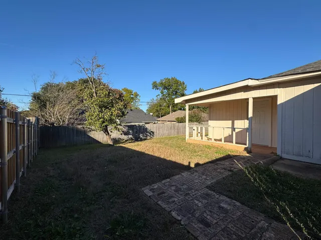 a view of a house with pool and a yard
