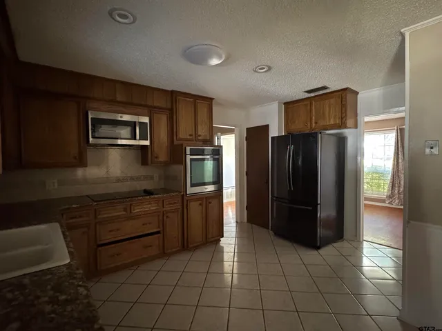a kitchen with a refrigerator and a sink