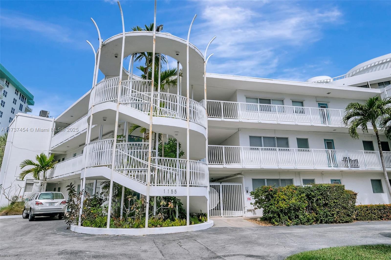1155 103rd Street, Unit 9B Bay Harbor Islands, FL 33154 - Photo 1 of 43 a front view of building with a yard