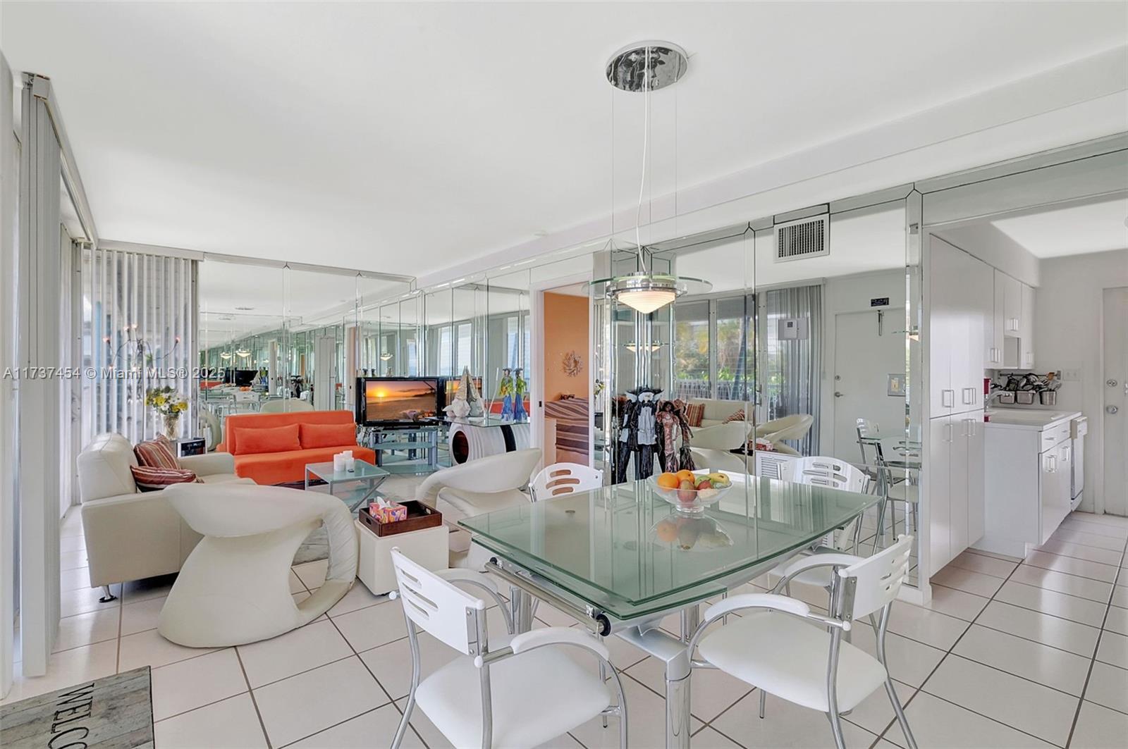 1155 103rd Street, Unit 9B Bay Harbor Islands, FL 33154 - Photo 12 of 43 a living room with furniture and a chandelier