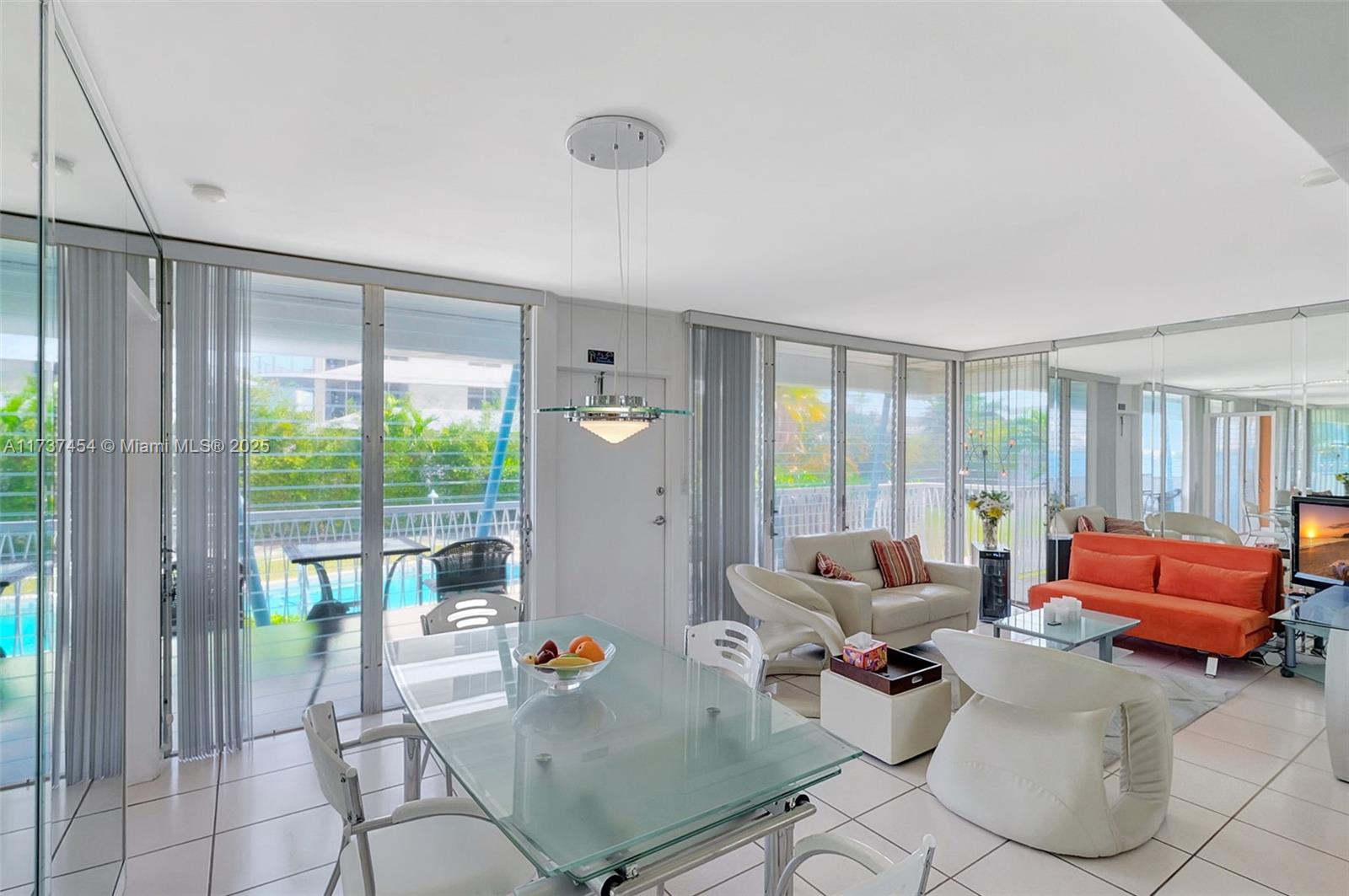 1155 103rd Street, Unit 9B Bay Harbor Islands, FL 33154 - Photo 13 of 43 a living room with furniture and a large window