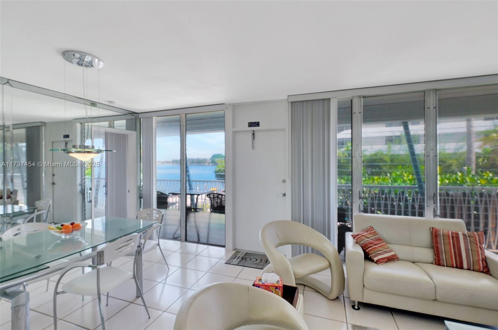 1155 103rd Street, Unit 9B Bay Harbor Islands, FL 33154 - Photo 16 of 43 a living room with furniture and a large window
