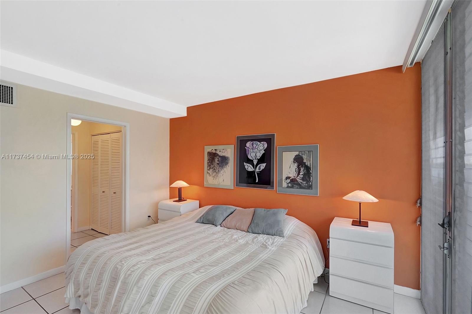 1155 103rd Street, Unit 9B Bay Harbor Islands, FL 33154 - Photo 20 of 43 a bedroom with a bed and a painting on the wall
