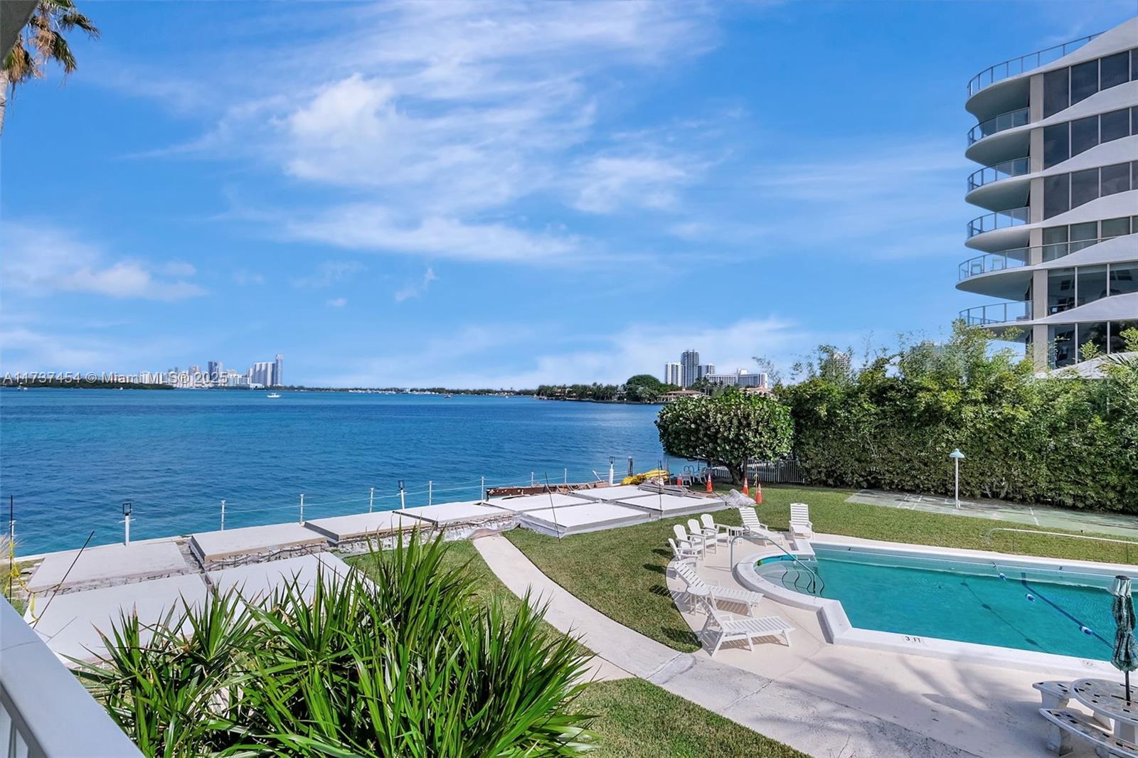 1155 103rd Street, Unit 9B Bay Harbor Islands, FL 33154 - Photo 2 of 43 a view of a swimming pool with a terrace