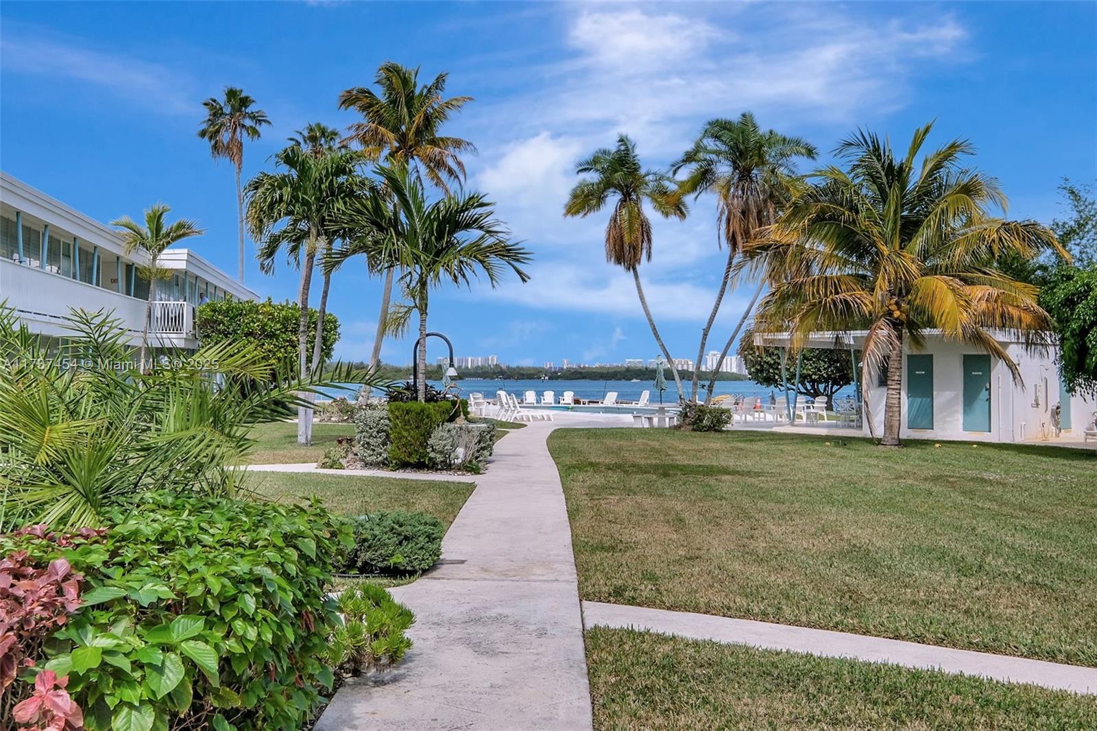 1155 103rd Street, Unit 9B Bay Harbor Islands, FL 33154 - Photo 3 of 43 a view of a palm trees in front of a building