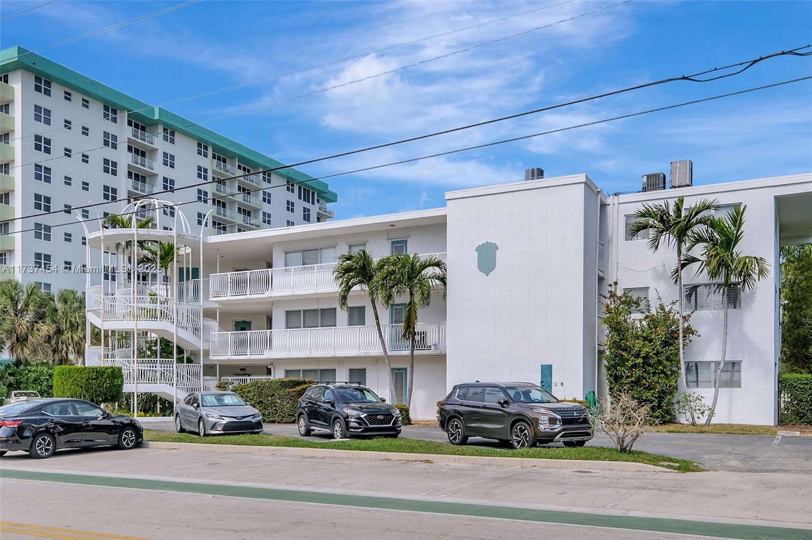 1155 103rd Street, Unit 9B Bay Harbor Islands, FL 33154 - Photo 42 of 43 a cars parked in front of a building