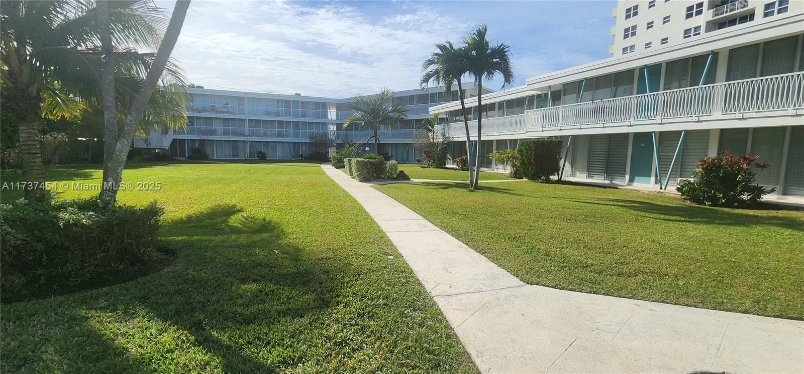 1155 103rd Street, Unit 9B Bay Harbor Islands, FL 33154 - Photo 6 of 43 a view of a backyard with a garden and plants