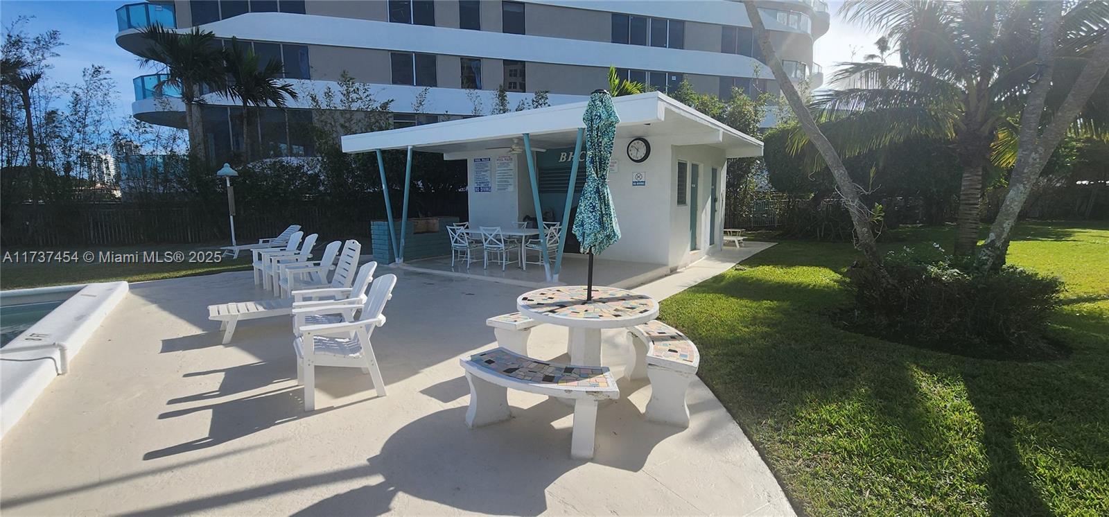 1155 103rd Street, Unit 9B Bay Harbor Islands, FL 33154 - Photo 9 of 43 a view of a patio with table and chairs potted plants