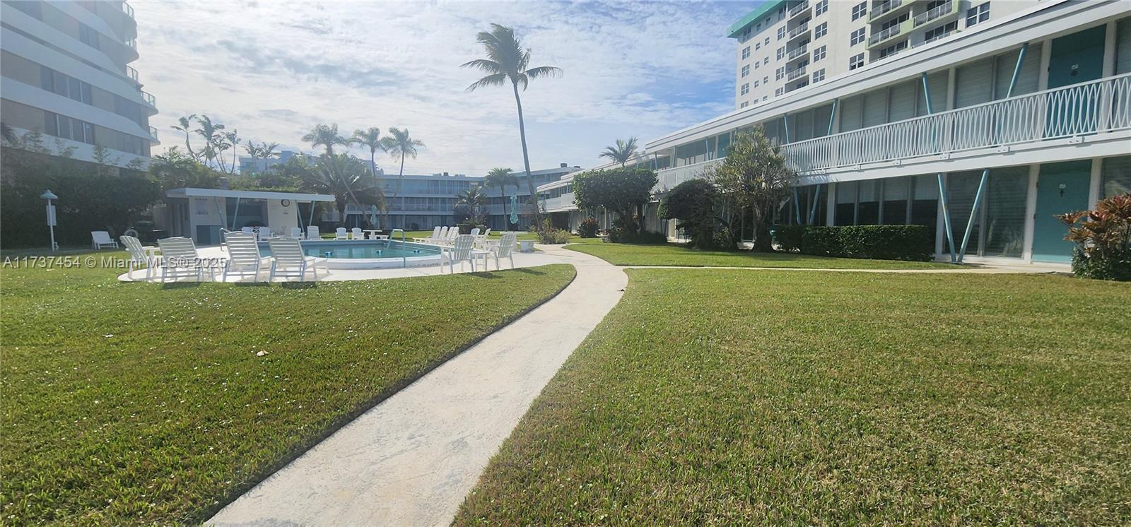 1155 103rd Street, Unit 9B Bay Harbor Islands, FL 33154 - Photo 10 of 43 a view of a swimming pool with a garden