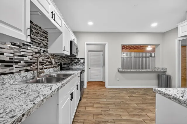 a kitchen with a sink and a refrigerator