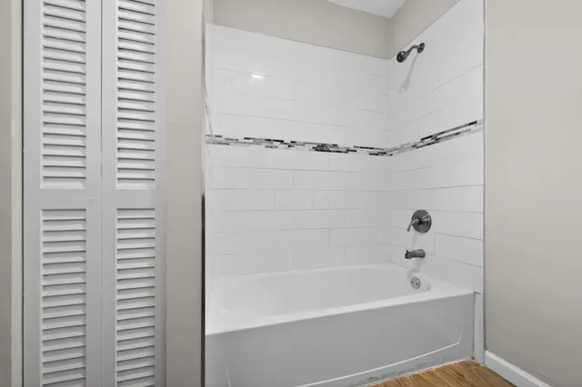 a bathroom with bathtub and shower