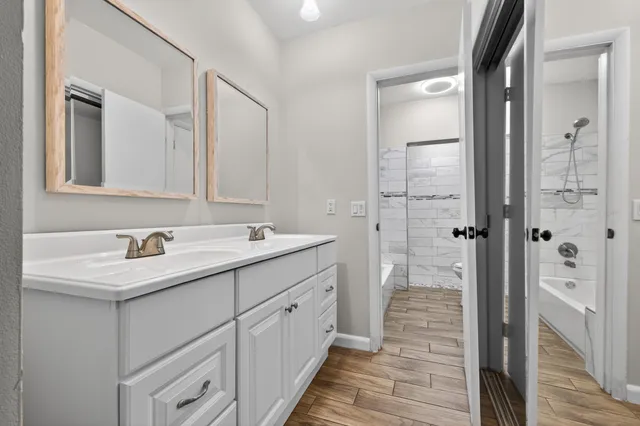 a bathroom with a double vanity sink and mirror