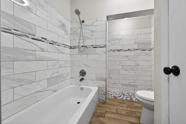 a bathroom with a bathtub and a shower