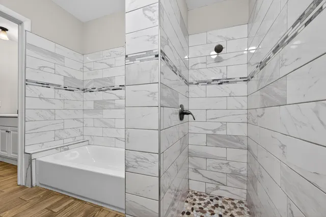 a bathroom with a bathtub and shower