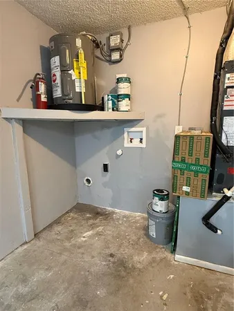 a room with a refrigerator and wooden floor