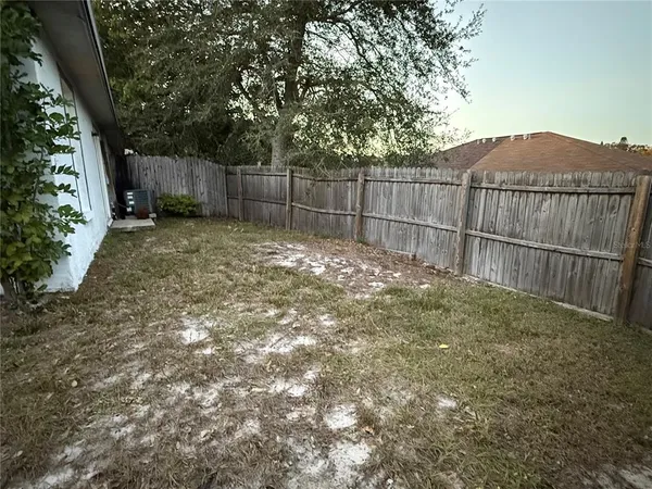 a view of house with backyard and porch