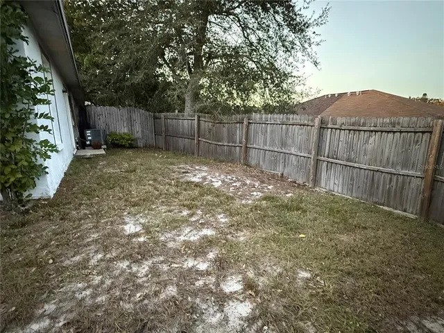 a view of house with backyard and porch