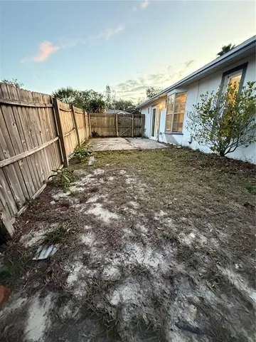 a view of a backyard with a fence