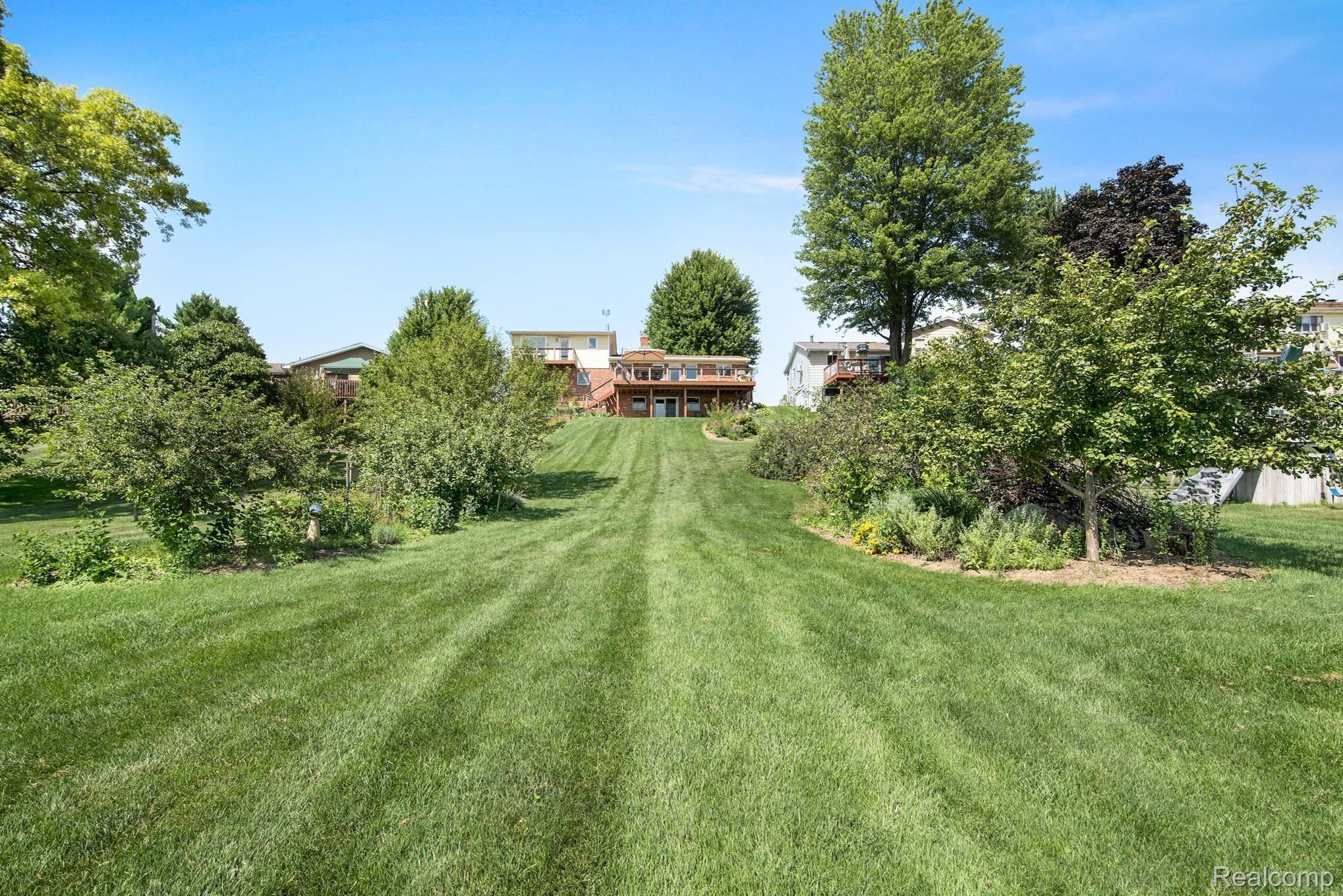 1231 Crooked Lake Road Fenton, MI 48430 - Photo 42 of 48 Full view of backyard, rear of house.jpg