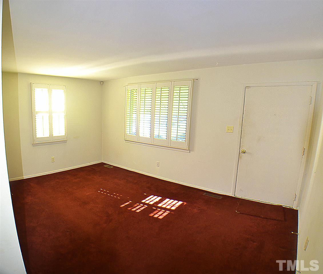 856 Hadley Road Raleigh, NC 27610 - Photo 2 of 13 an empty room with a window