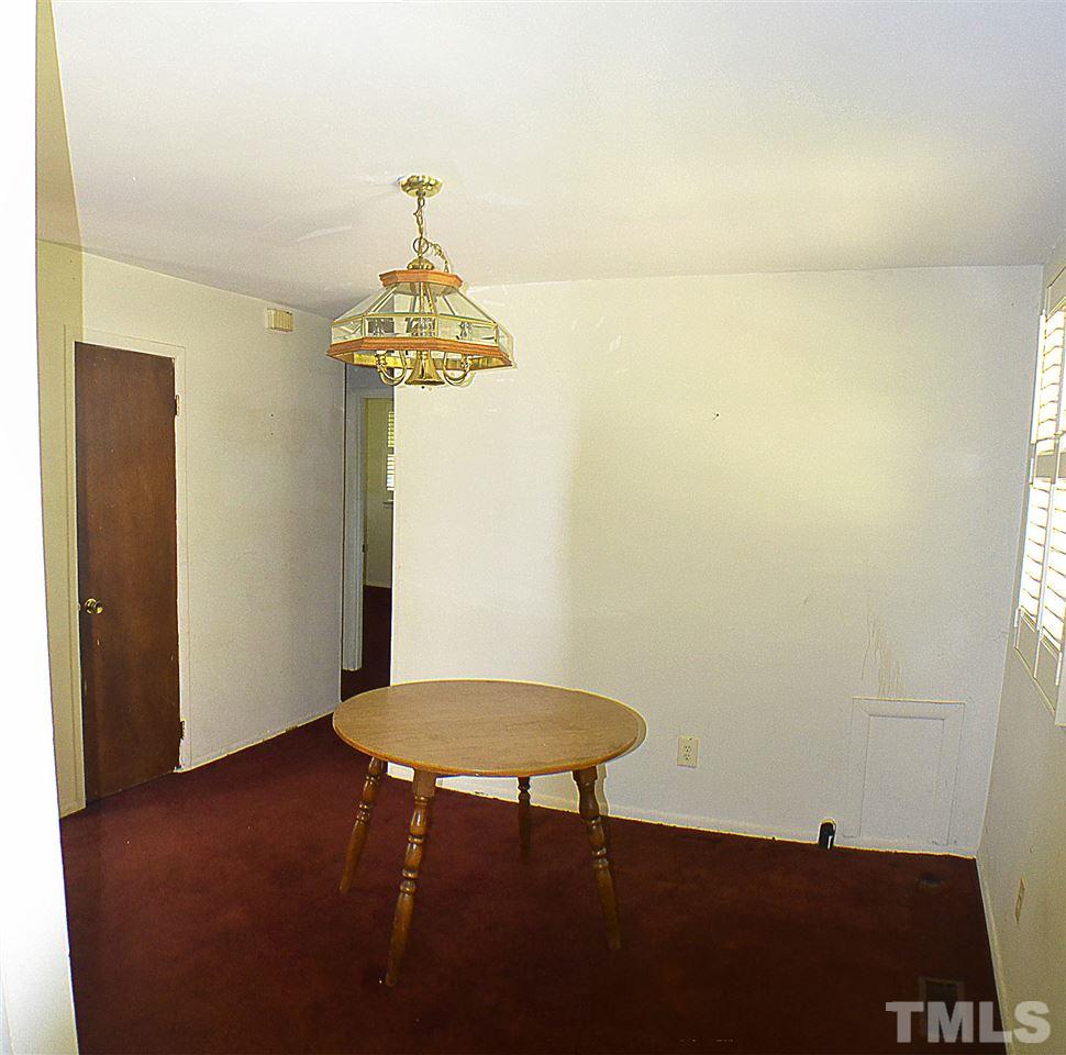 856 Hadley Road Raleigh, NC 27610 - Photo 4 of 13 a room with a table and a chair