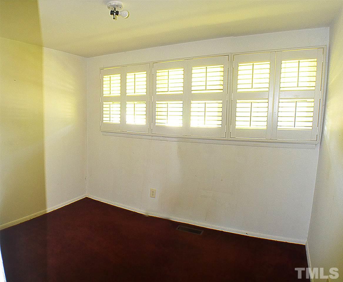 856 Hadley Road Raleigh, NC 27610 - Photo 6 of 13 a view of an empty room with a window