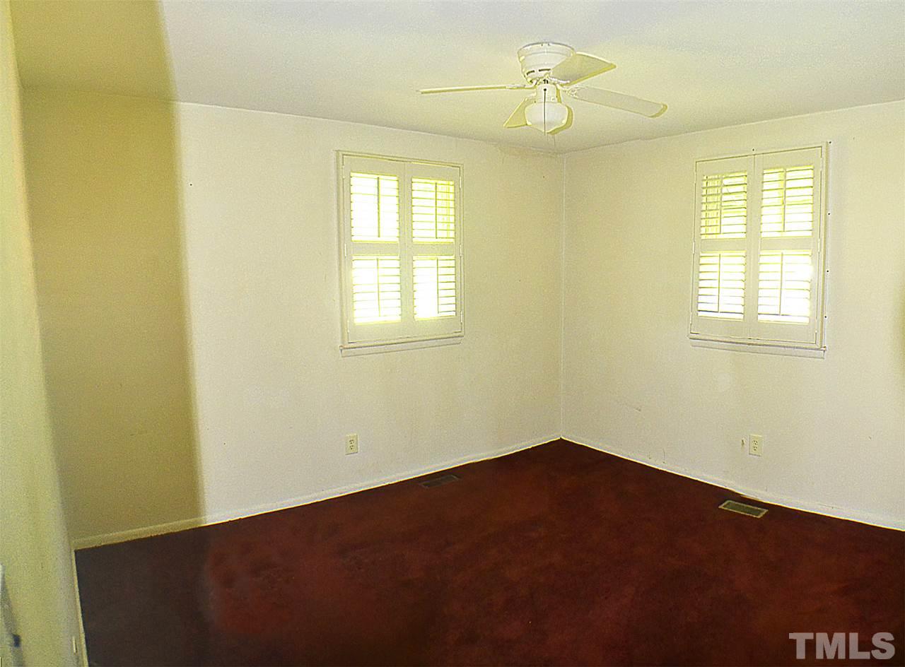 856 Hadley Road Raleigh, NC 27610 - Photo 8 of 13 an empty room with a window