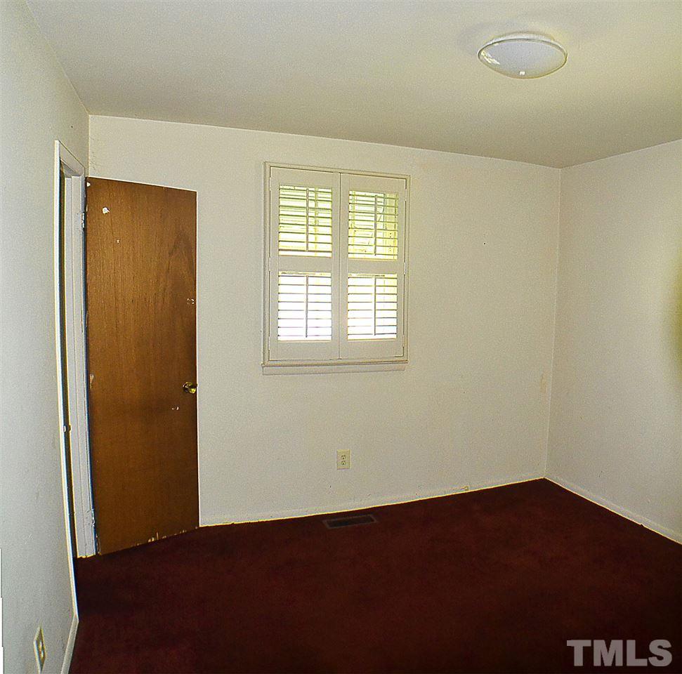 856 Hadley Road Raleigh, NC 27610 - Photo 9 of 13 an empty room with a window