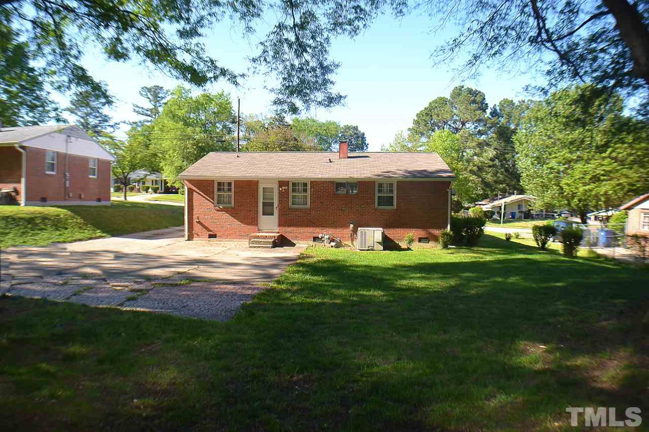 856 Hadley Road Raleigh, NC 27610 - Photo 10 of 13 a view of a house with a big yard and large trees