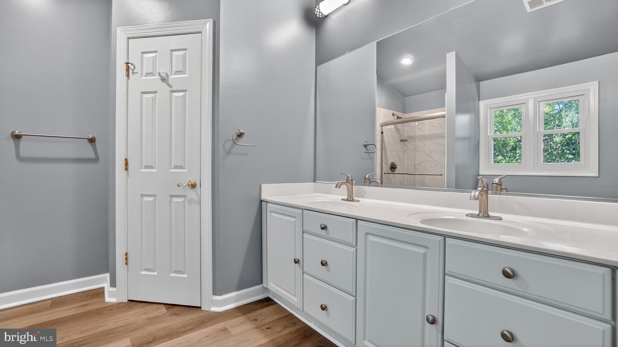 2812 Brite Court Crofton, MD 21114 - Photo 31 of 55 a bathroom with a double vanity sink and mirror with window