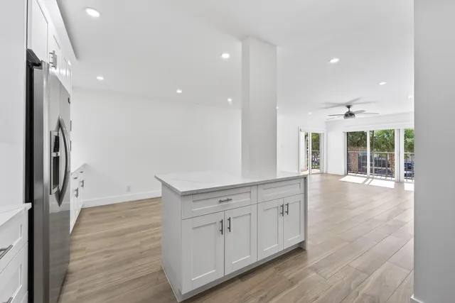 a view of a kitchen with a sink and a refrigerator