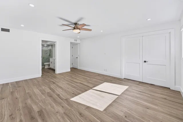 a view of hallway with stairs and wooden floor