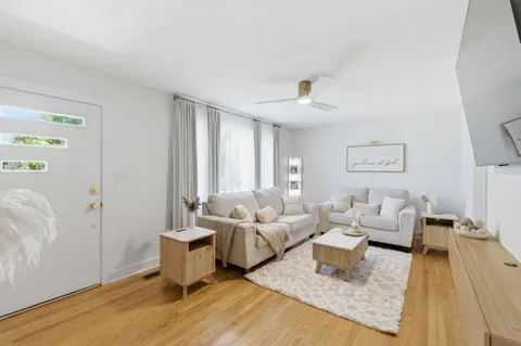 a living room with furniture and wooden floor