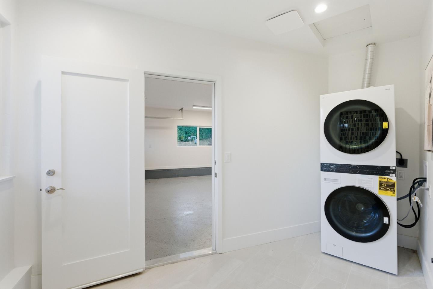670 La Mesa Drive Portola Valley, CA 94028 - Photo 28 of 43 a view of a hallway with washer and dryer