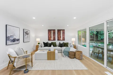 a living room with furniture and large window