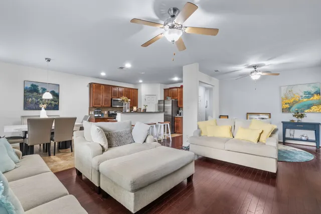a living room with furniture and a view of kitchen