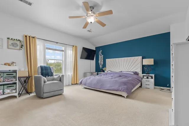 a bedroom with a bed and ceiling fan