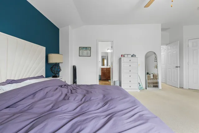 a bedroom with a large bed and a dresser