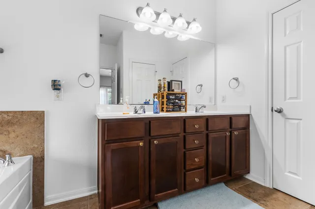 a bathroom with a double vanity sink and a mirror