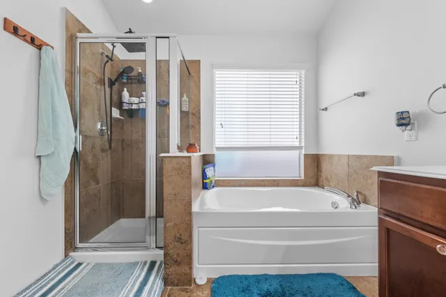 a bathroom with a tub and shower