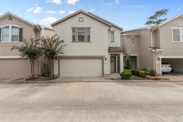 a front view of a house with garage