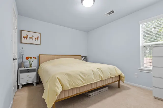 a large bed sitting in a bedroom next to a window