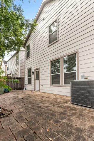 a view of house with backyard and glass windows