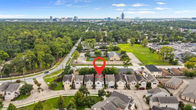 an aerial view of residential houses with outdoor space and swimming pool