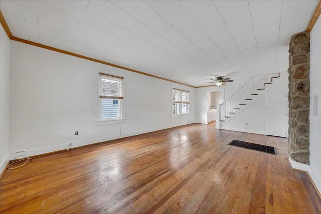 wooden floor in an empty room with a window