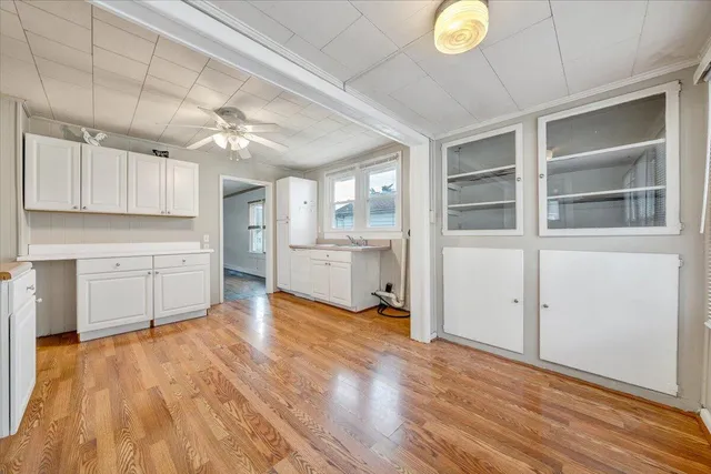 a view of a kitchen with wooden floor and a sink